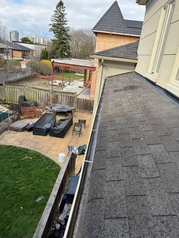 Cleaned gutter on a lower roof in a Toronto backyard
